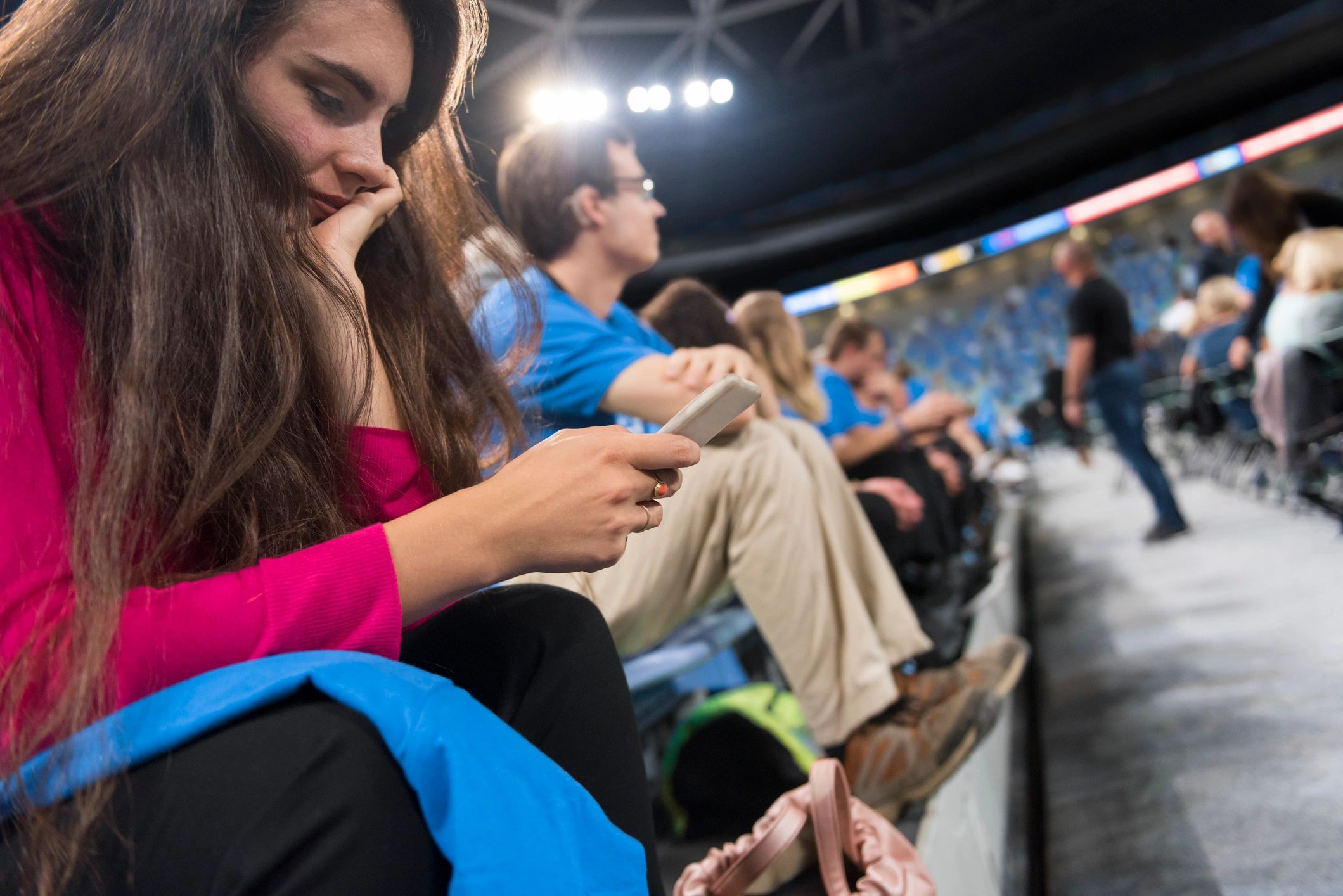 Person using a smartphone at a stadium