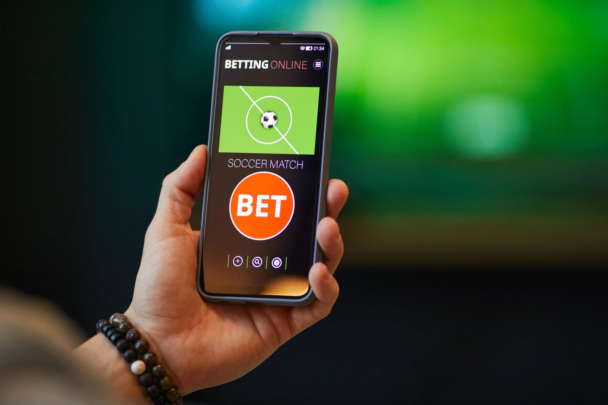 Hand Holding Smartphone Displaying Soccer Betting Application